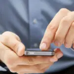 Man holding a smartphone, representing legal consultation and client communication.