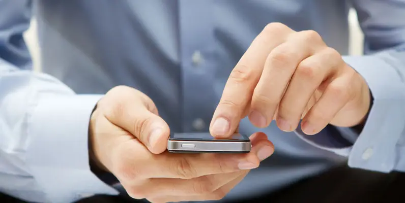 Man holding a smartphone, representing legal consultation and client communication.