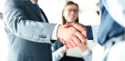 Close-up of a handshake, symbolizing trust, partnership, and legal agreements.