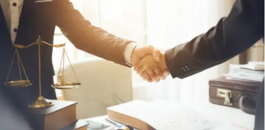 Close-up of a handshake, representing trust, partnership, and legal agreements.