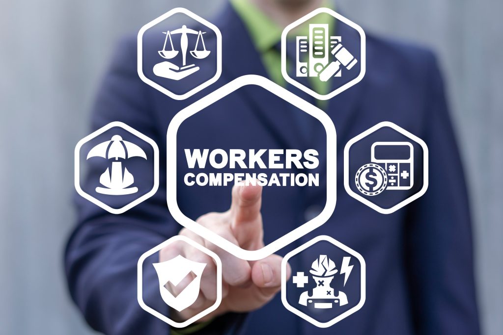 Businessman pressing virtual screen with workers' compensation icons and insurance symbols.