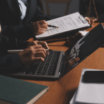Attorney qualifying legal leads using a laptop in a modern law office