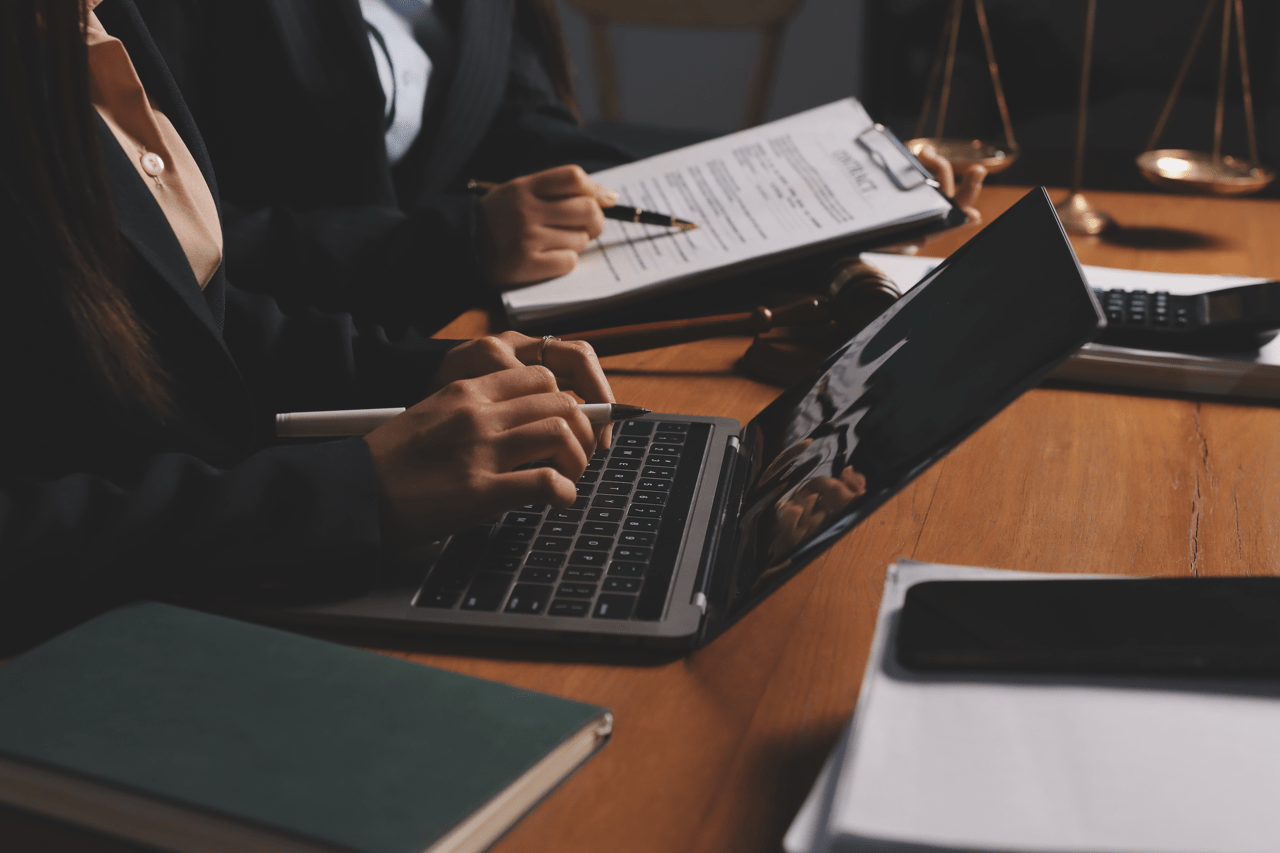 Attorney qualifying legal leads using a laptop in a modern law office