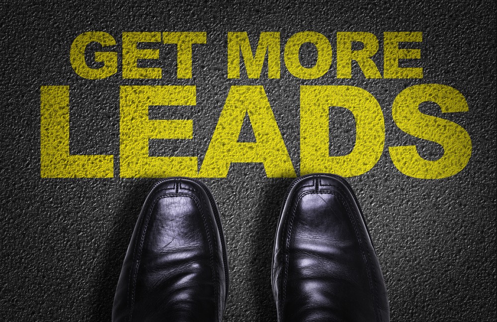 Get More Leads text on asphalt with business shoes in view