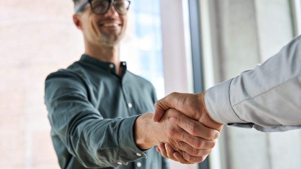 Lawyer sealing a high-value client deal with a handshake, symbolizing how to make $300K a year as a lawyer