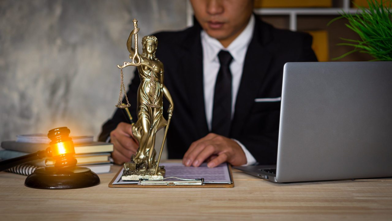 Law firm marketing team reviewing legal lead generation costs and ROI metrics on a laptop