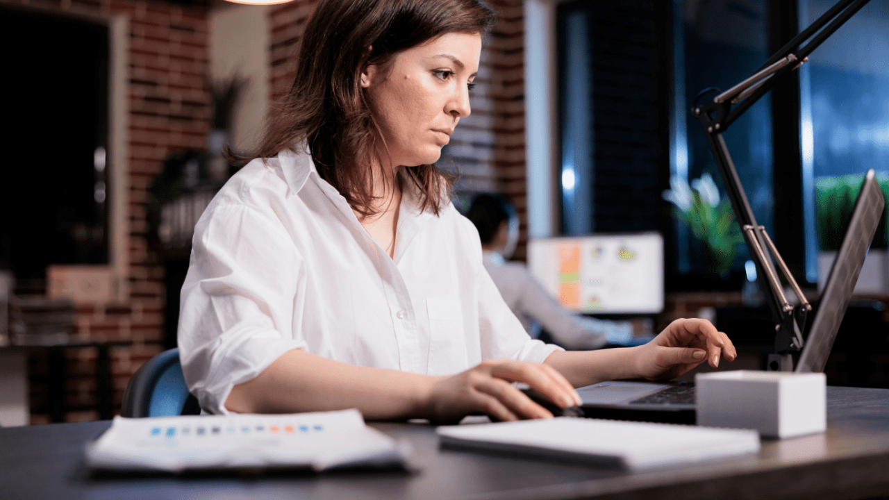 A legal lead generation specialist reviewing digital campaign analytics under time pressure in a fast-paced office environment