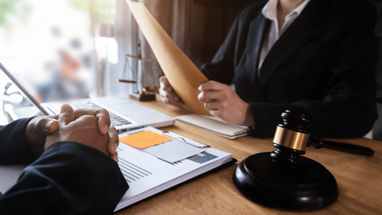 Client meeting with California bankruptcy lawyer to discuss Chapter 7 fees, showing legal documents, gavel, and consultation setup