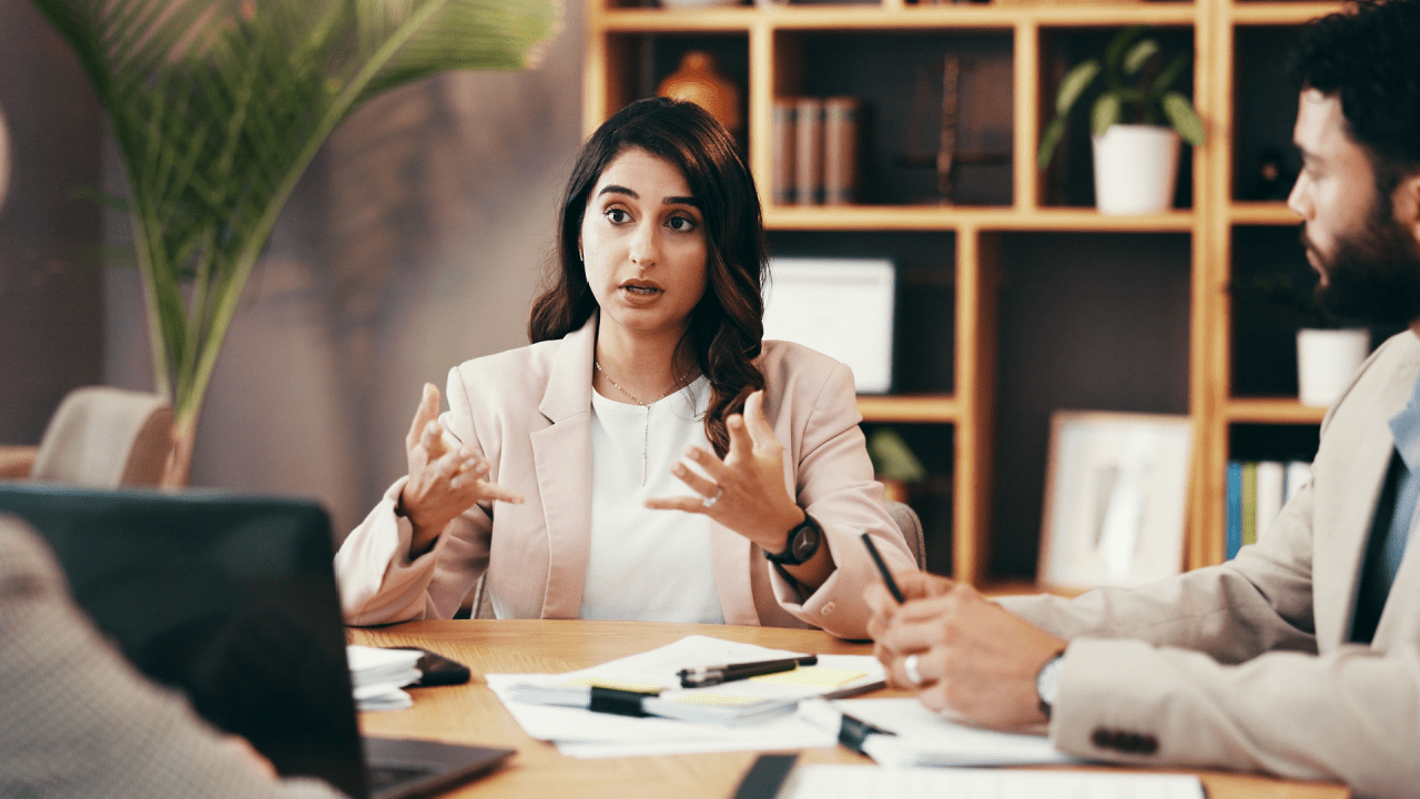 Woman discussing average price of bankruptcy leads during business meeting with financial advisors