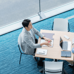 Two business professionals collaborating on marketing strategies for bankruptcy lawyers in modern office space