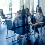 Professional team meeting about generating quality leads for bankruptcy attorneys in modern glass-walled office