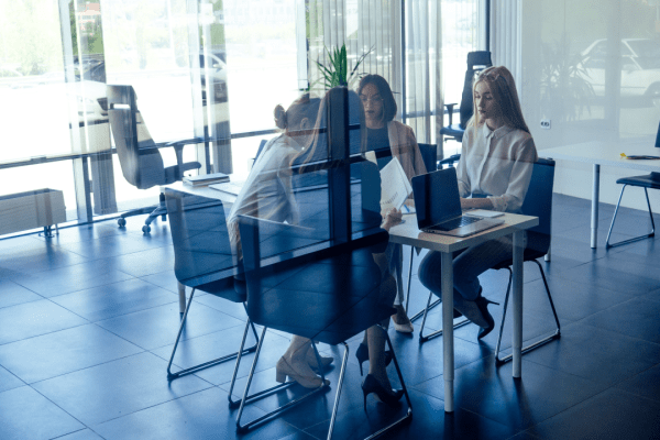 Professional team meeting about generating quality leads for bankruptcy attorneys in modern glass-walled office