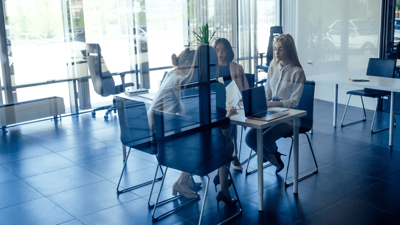 Professional team meeting about generating quality leads for bankruptcy attorneys in modern glass-walled office